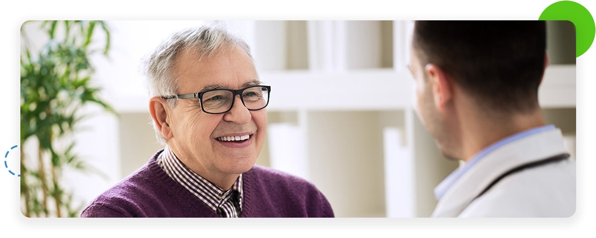 Smiling patient talking to doctor